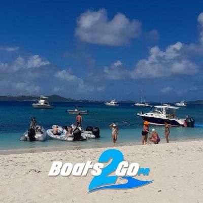 a group of people sitting at a beach