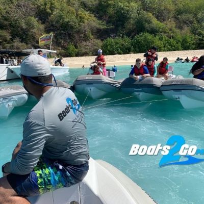 a group of people riding on the back of a boat