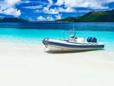 a boat sitting on top of a sandy beach